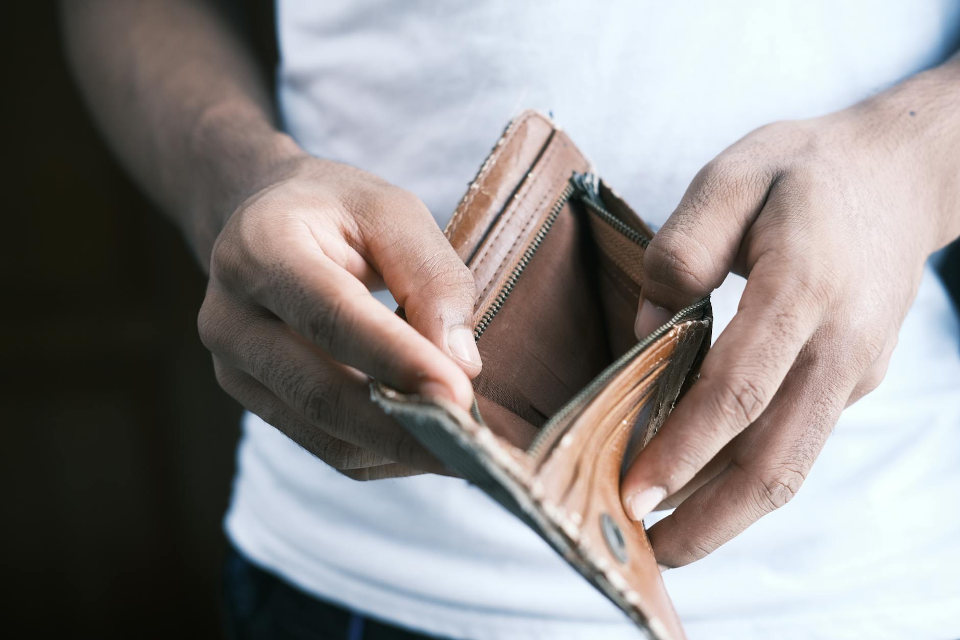 person holding an empty wallet